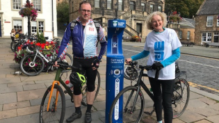 Two people at Top Up Tap with bikes 