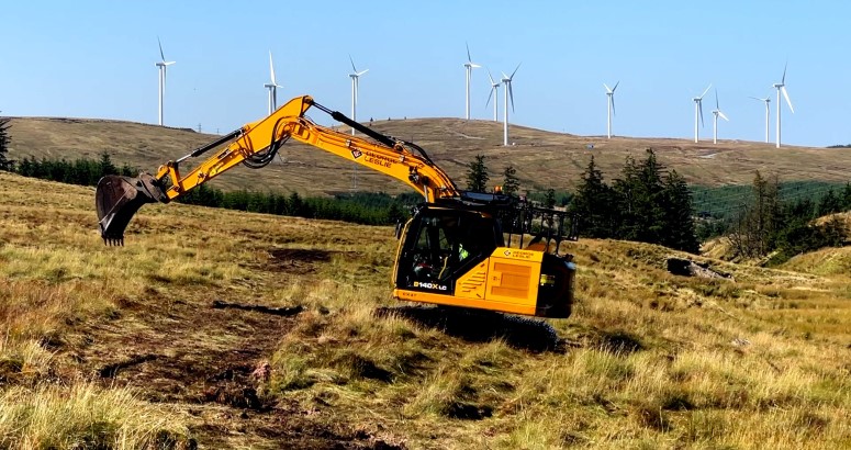 A digger at work on a peatland restoration site at Afton Reservoir, East Ayrshire