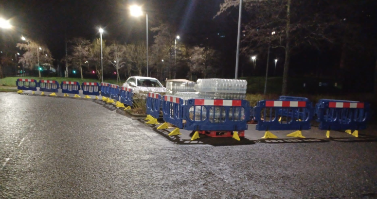 Customers collecting water from a temp water station 