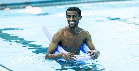 Amanuel Akalu in the pool with Learn to Swim teacher Lucy McCluskey