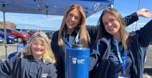 Three Scottish Water employees happy beside Top Up Tap