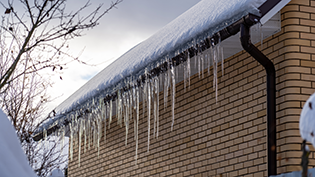 Icicles hanging from a roof in winter